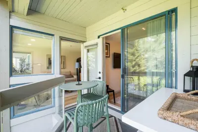 a screened in porch with a table and chairs at Greystone Lodge by Outpost Whistler in Whistler