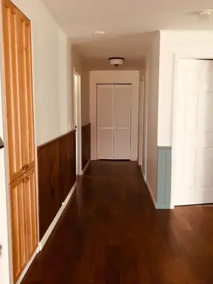 an empty hallway of a house with a door at Blue Cypress Suite- Downtown Tofino in Tofino