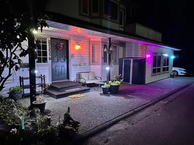 a house with purple lights on the front of it at Golden Ears Serenity in Maple Ridge District Municipality