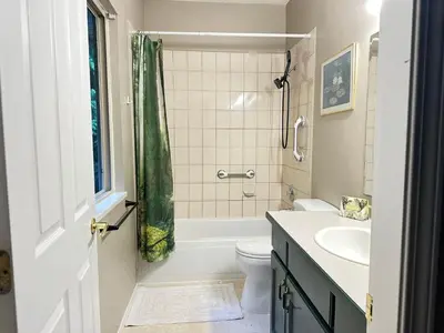 a bathroom with a tub and a toilet and a sink at Golden Ears Serenity in Maple Ridge District Municipality