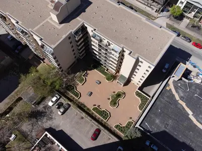 an overhead view of a building with a parking lot at Cozy & Spacious 2BR at Stampede w Parking and AC in Calgary