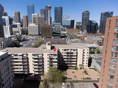 a view of a city skyline with a large building at Cozy & Spacious 2BR at Stampede w Parking and AC in Calgary
