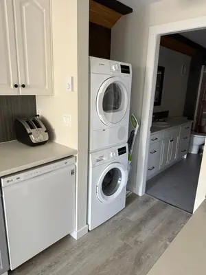 a kitchen with a washing machine and a washer at Beach Bed and Breakfast in Grand Forks