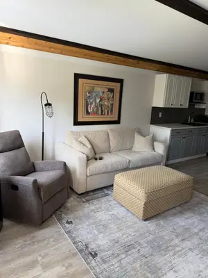 a living room with a couch and a chair at Beach Bed and Breakfast in Grand Forks
