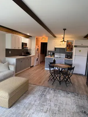 a kitchen and living room with a table and chairs at Beach Bed and Breakfast in Grand Forks