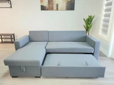 a blue couch sitting in a living room at Winter Deal! Stunning Ocean View Modern 1 BDR Private Entry Suite in Colwood
