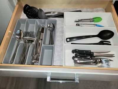 a drawer filled with silver utensils in a box at Winter Deal! Stunning Ocean View Modern 1 BDR Private Entry Suite in Colwood