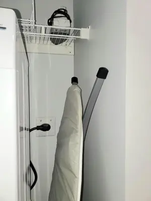 a pillow hanging on a wall next to a shelf at Winter Deal! Stunning Ocean View Modern 1 BDR Private Entry Suite in Colwood