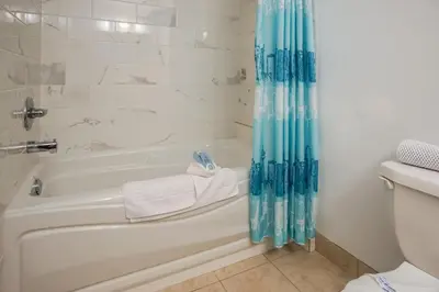 a bathroom with a bath tub and a toilet at Gables Motel in Radium Hot Springs