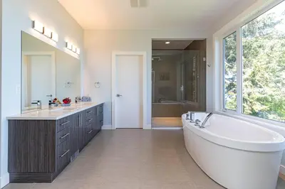 a bathroom with a large tub and a large window at Come On In, The Water View Is Waiting For You,,, in Oak Bay