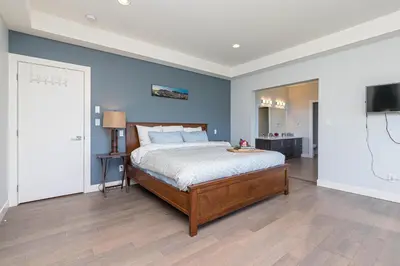 a bedroom with a bed and a television in it at Come On In, The Water View Is Waiting For You,,, in Oak Bay