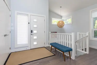 a white staircase with a blue bench in a room at Come On In, The Water View Is Waiting For You,,, in Oak Bay