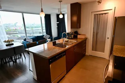 a kitchen and living room with a large window at Lucy's House in Vancouver