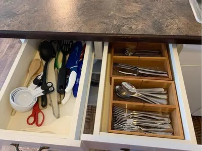 a cabinet filled with utensils under a counter at Banff Boundary Lodge Mountain View 2Brms 3xAC Townhouse in Canmore