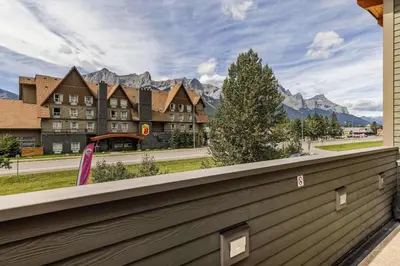 a balcony with a view of a hotel and mountains at Alps #201- LEED Gold Certified in Canmore