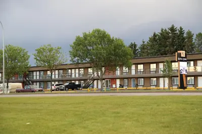 a large building with a grass field in front of it at Royal Lodge in Edmonton