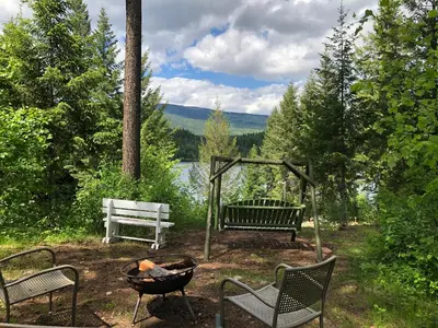 a fire pit with two chairs and a bench at Hotel Civilia Lakeside by Civilia Golf Retreat in Clearwater