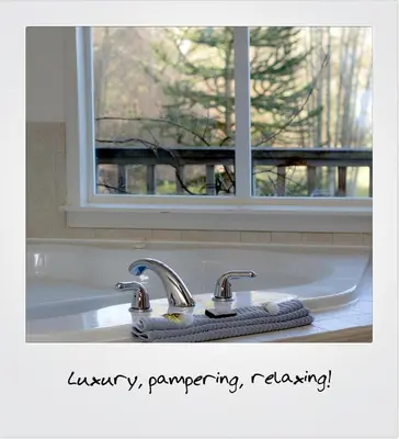 a bathroom sink with two faucets and a window at Quarrystone House B&B in Fernwood