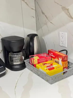 a tray of food on a counter next to a coffee maker at Modern Comfort in West Edmonton in Edmonton