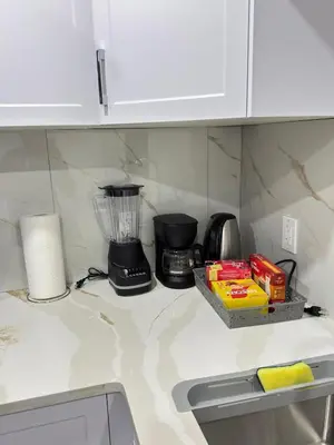 a kitchen counter with a blender on top of it at Modern Comfort in West Edmonton in Edmonton