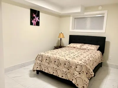 a bedroom with a bed and a window at Sunny White Rock 2BR, Steps to Sand, Brand New Stay in White Rock