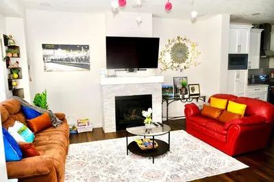 a living room with two couches and a fireplace at Mahogany Loft Retreat - 3 Story Home in Calgary