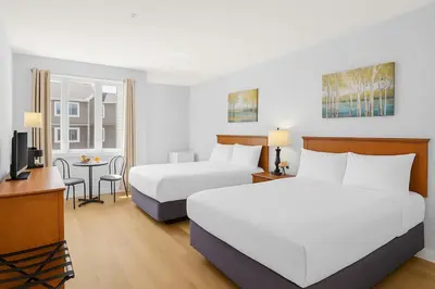 a hotel room with two beds and a table at Chic Mountain Hideout in Canmore DT Near Banff! in Canmore
