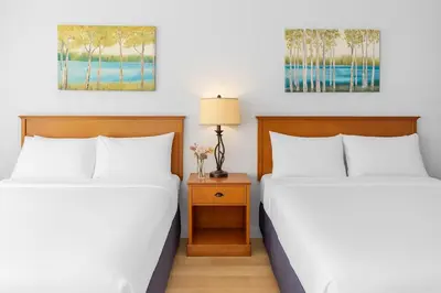 two beds sitting next to each other in a room at Chic Mountain Hideout in Canmore DT Near Banff! in Canmore