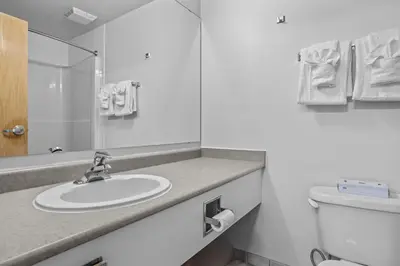 a white bathroom with a sink and a toilet at Chic Mountain Hideout in Canmore DT Near Banff! in Canmore