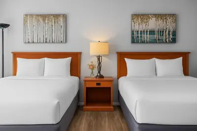 two beds sitting next to each other in a room at Perfect Canmore Getaway for 4 plus Exclusive Savings in Canmore