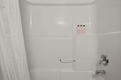 a white bathroom with a shower and a sink at Perfect Canmore Getaway for 4 plus Exclusive Savings in Canmore