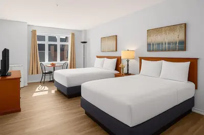 a hotel room with two beds and a television at Perfect Canmore Getaway for 4 plus Exclusive Savings in Canmore