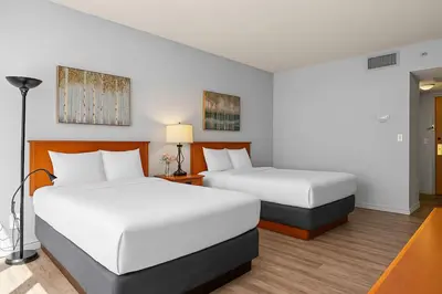 a hotel room with two beds and a lamp at Perfect Canmore Getaway for 4 plus Exclusive Savings in Canmore