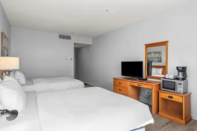 a hotel room with two beds and a television at Perfect Canmore Getaway for 4 plus Exclusive Savings in Canmore