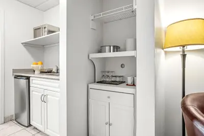 a kitchen with white cabinets and a lamp at Cozy Hideaway with MTN Views Near DT Canmore and Banff in Canmore