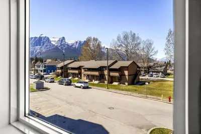 a view from a window of a street with a building at Cozy Hideaway with MTN Views Near DT Canmore and Banff in Canmore