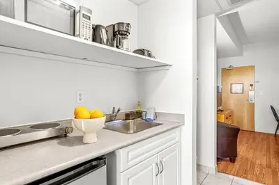 a kitchen with a sink and a bowl of fruit on the counter at Cozy Hideaway with MTN Views Near DT Canmore and Banff in Canmore