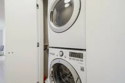a washer and dryer in a room at Gorgeous Water View Unit in Downtown Vancouver in Vancouver