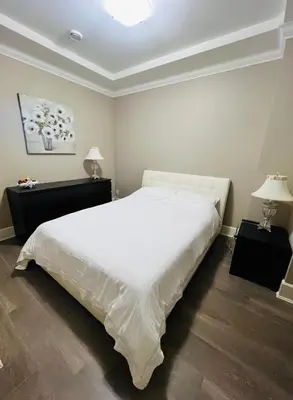 a bedroom with a large white bed and two lamps at 3Bed 2Bath Steam Sauna Retreat! Family friendly! in Vancouver