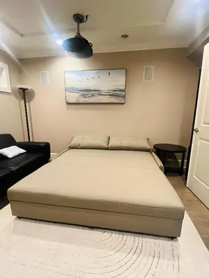 a bedroom with a bed in a room with a couch at 3Bed 2Bath Steam Sauna Retreat! Family friendly! in Vancouver