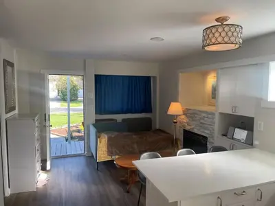 a living room with a kitchen and a living room with a bed at Private Luxury Relaxing HOME w BBQ & Gas Fire-pit in Hope