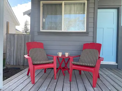 two red chairs and a table on a porch at Private Luxury Relaxing HOME w BBQ & Gas Fire-pit in Hope