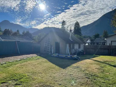 a yard with a house with a boat on the grass at Private Luxury Relaxing HOME w BBQ & Gas Fire-pit in Hope