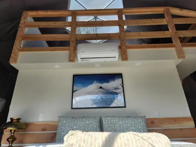 a living room with a bed and a ceiling at Alpenrose Dome Hottubs Mountains view sleep 4 in Golden
