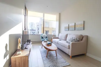 a living room with a couch and a table at Beautiful Downtown Unit in Vancouver