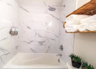 a white bathroom with a sink and white towels at Beautiful Downtown Unit in Vancouver