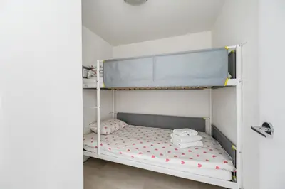 a bunk bed with towels on it in a room at Bright 3BR Downtown Vancouver Condo w Pool & Gym in Vancouver