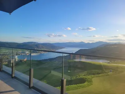 a room with a view of a lake and mountains at Creekside Oasis on Mara in Sicamous