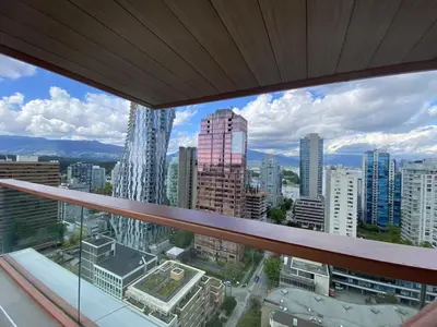 a view of a city from a window in a building at Brand New Modern 2 BR Condo in Heart of Downtown Vancouver in Vancouver