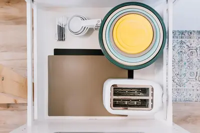 a plate on top of a microwave in a box at Adventure Knap Shack in Nordegg